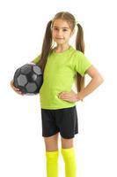 Vertical portrait of beautiful young girl with soccer ball in hands photo