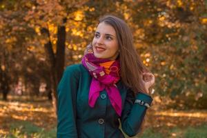 charming young girl smiling and looks toward the street photo