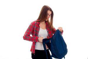 pretty young brunette students teenager in stylish clothes and backpack in her hands posing isolated on white background photo