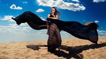 Woman with dress flying in the desert photo