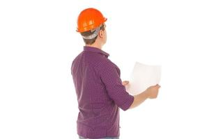 builder in helmet with plan in hands photo