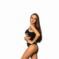 young beautiful brunette in black body swimsuit photo