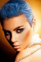 Vertical photo of sexy young woman with blue hair and green makeup