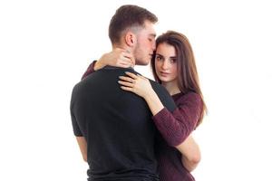 Cute young couple in love hugging in studio photo