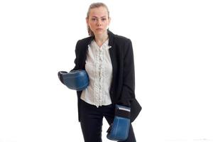 beautiful girl in black business jacket and white shirt posing on camera with boxing gloves on hand photo