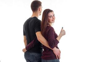 young couple hugging waist and girl showing thumbs up photo