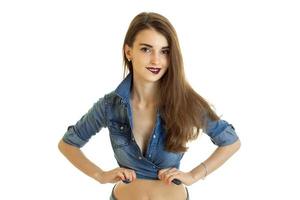 Cutie young girl in jeans t-shirt without bra bite a lips photo