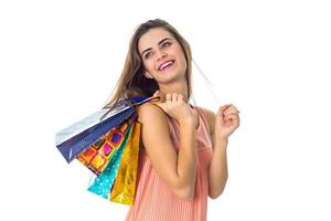 happy girl keeps on shoulder bright bags isolated  white background photo