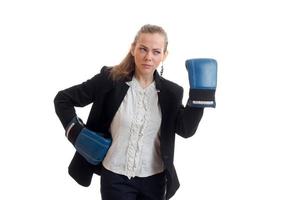 charming young girl in shirt and jacket looks away and wore boxing gloves on hands photo