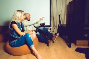 Man playing computer games and having some fun with beautiful woman photo