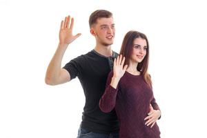 young smiling boy and girl raised palms up and look forward photo