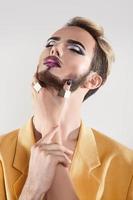 Sensual guy with makeup and healthy skin in studio photo