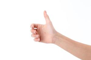 female hand showing the gesture with a raised thumb up isolated on white background photo