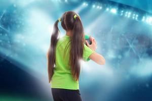 girl in green shirt with soccer ball photo