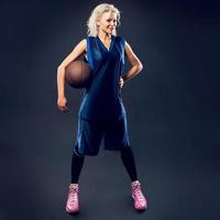 Woman basketballer in blue jersey photo