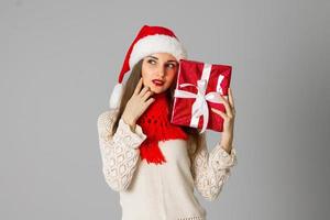 girl in santa hat with gift photo