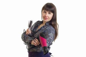 Charming woman stylist with tools in hands posing on camera photo
