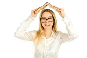 girl in glasses holding a book above the head photo