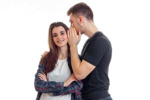 young tall guy stands and Whispers in her ear the word and girl smiling photo