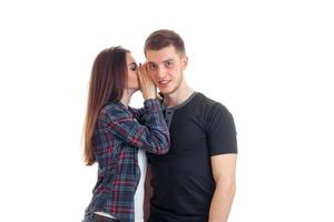 young girl whispering guy in his ear photo