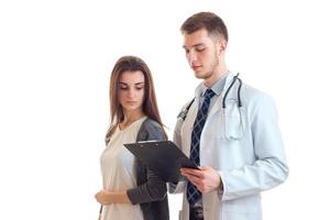 the doctor standing next to a girl and shows her the results of analyses on the Tablet photo