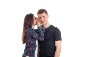 girl whispers in the ear of her boyfriend photo