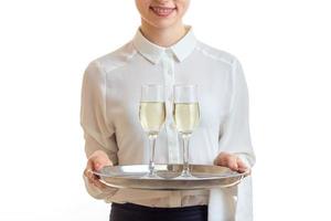 waitress in uniform holding a champagne on silver trey photo