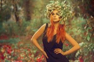 Nice young redhair lady with hop on head posing in outdoor photo