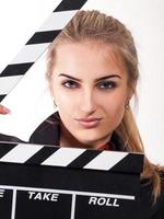 Portrait of beautiful girl with film slate photo