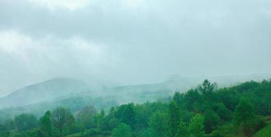 Rainy cloudy landscape of green mountains photo