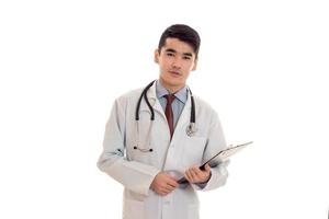 studio portrait of beauty male doctor in uniform posing isolated on white background photo