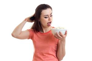 funny brunette woman with pop-corn in hands photo