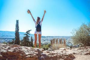 girl stands on the ruins of ancient Greece photo