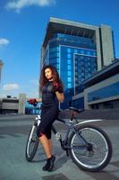 sexual slim young sports woman on bicycle photo