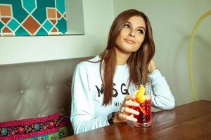 brunette with green eyes posing in the cafe photo