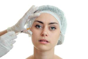 a beautiful young woman makes a prick from a plastic surgeon photo