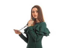 Cute brunette lady in green dress with microphone photo