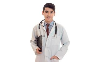 young handsome male doctor with stethoscope in uniform isolated on white background photo