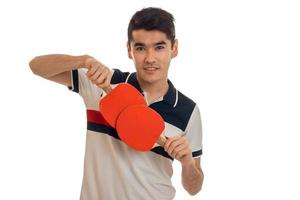 handsome young brunett sportsman practicing ping-pong isolated on white background photo