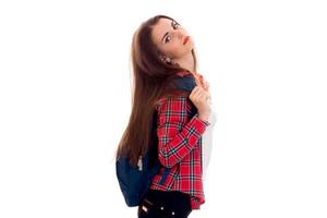 tired young brunette student girl with blue backpack posing and looking at the camera isolated on white background photo