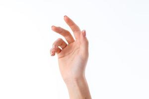 female hand stretched up and showing the gesture with a slightly bent fingers isolated on white background photo