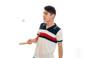 portrait of handsome sportsman practicing table tennis in uniform isolated on white background photo