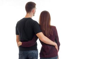 a young couple standing with his back to the camera and cuddling close-up photo