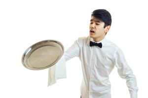 a young bumbling waiter drops on the floor of the empty tray is photo