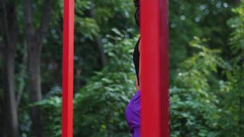 Woman performs yoga poses and stretches on outdoor stage video