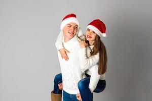 couple in love celebrates christmas in santa hat photo