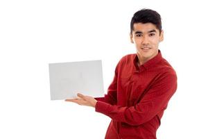 portrait of pretty young brunette male model with placard in hands isolated on white background photo