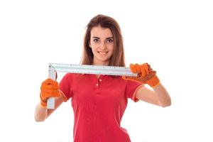 young girl holding a tool to repair the apartment and smiling photo