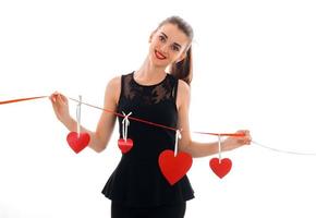 beautiful young brunette woman with red lips and heart in studio posing isolated on white background photo