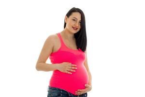 pretty pregnant brunette girl in big belly posing isolated on white background photo